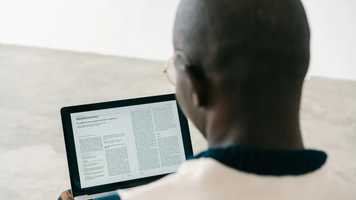 Person looking at a document on a laptop