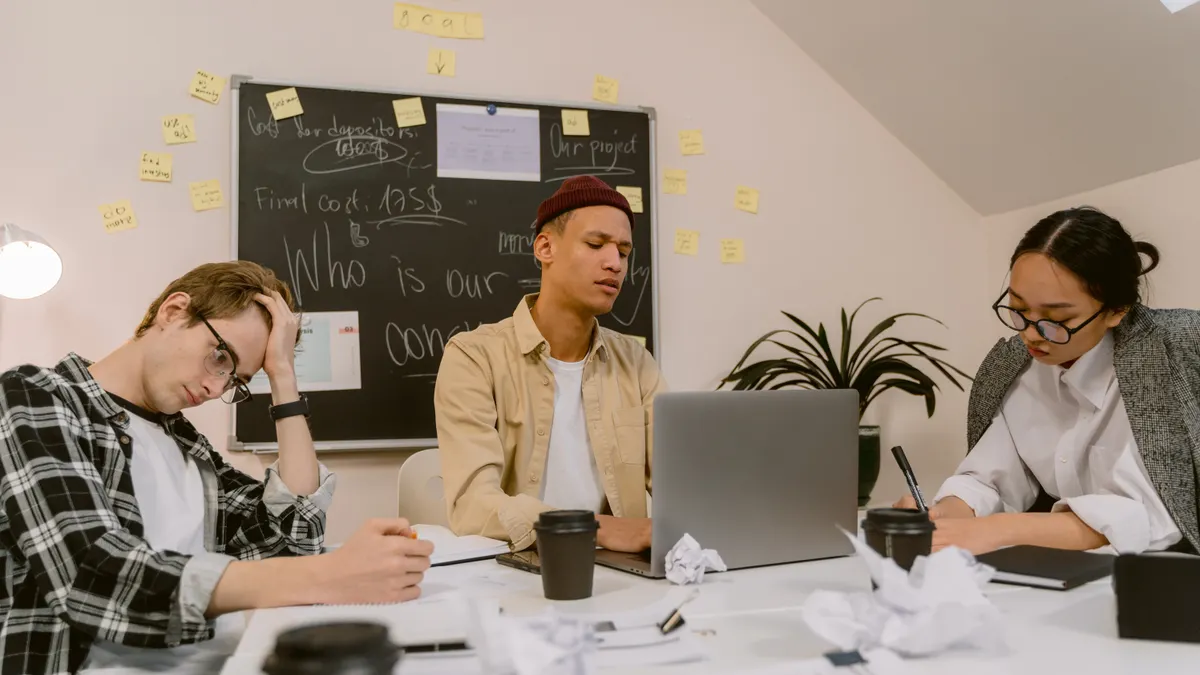 Grammar checker vs AI writer: which tool solves which problem Grammar checker vs AI writer: which tool solves which problem — A Woman Writing and Men Near a Blackboard in an Office